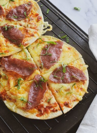 a couple of pizzas sitting on top of a pan